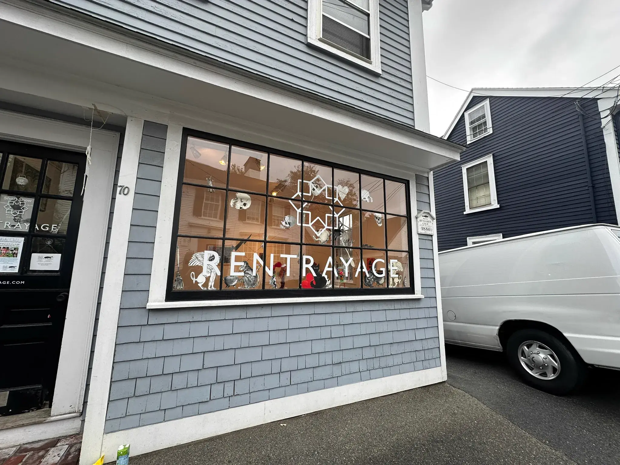 Rentrayage storefront window with cut vinyl lettering and illustrated figures