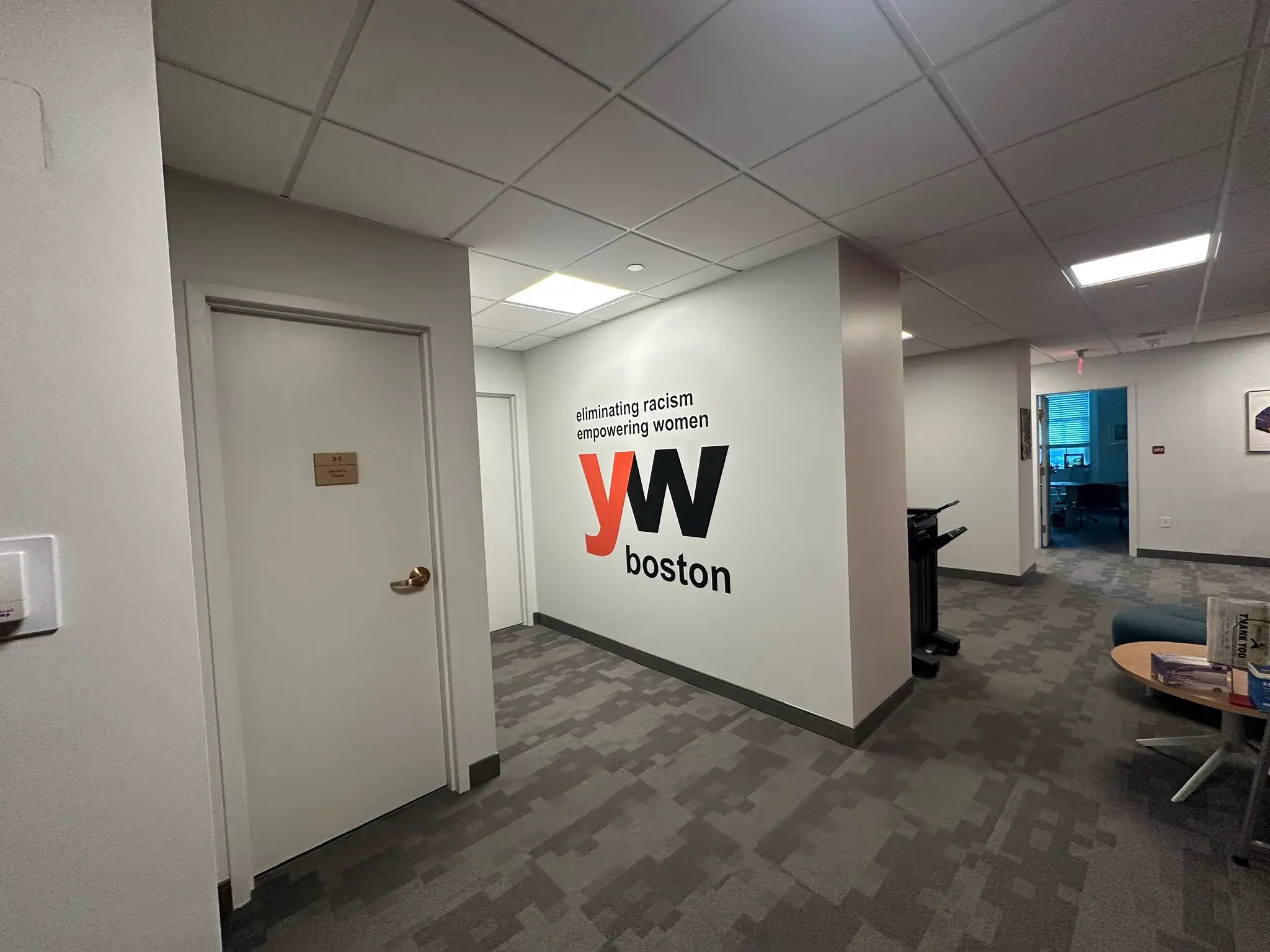 YW Boston eliminating racism empowering women wall graphic in an office corridor