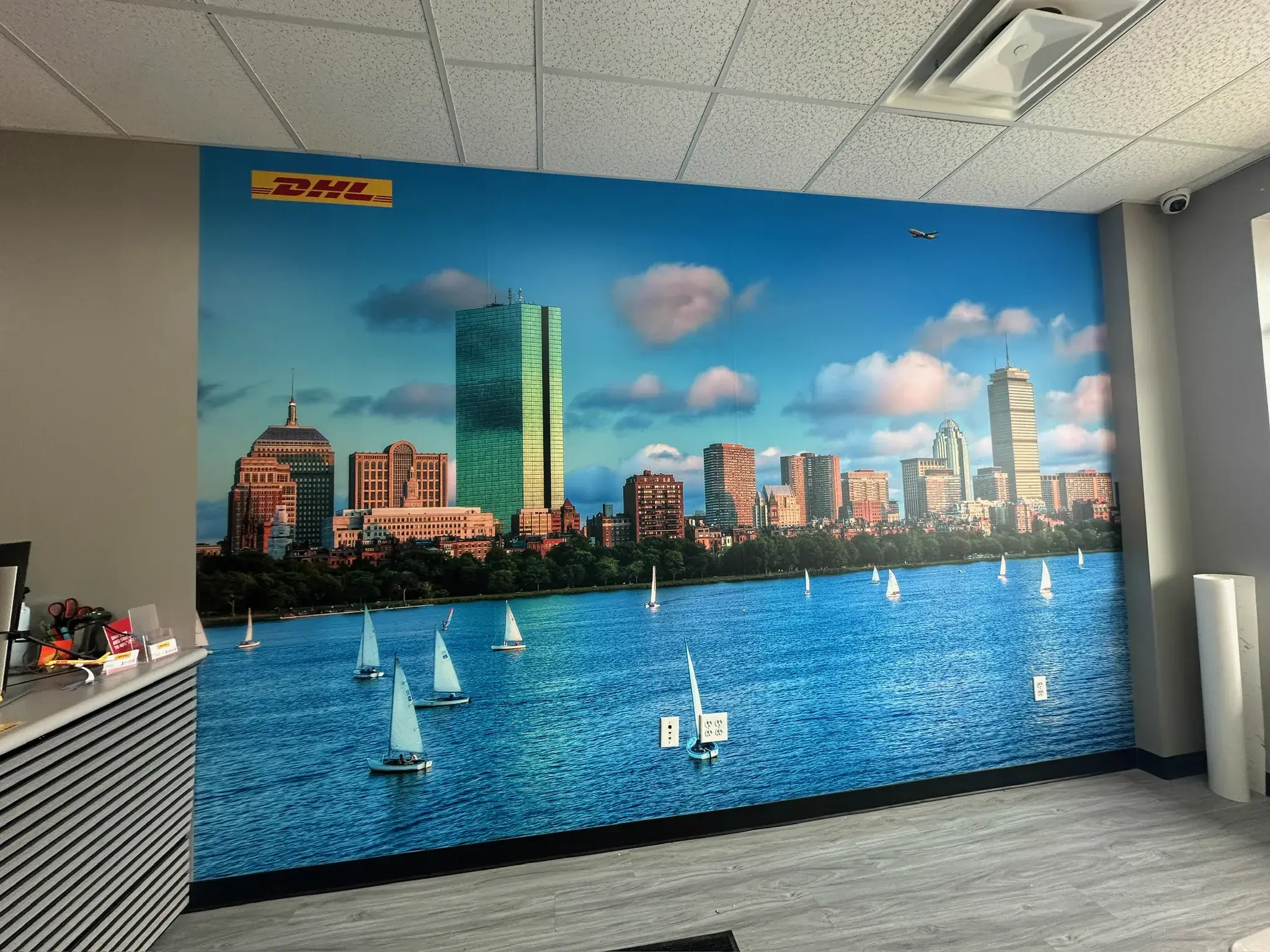 DHL Boston skyline and sailboats wall mural above a retail counter