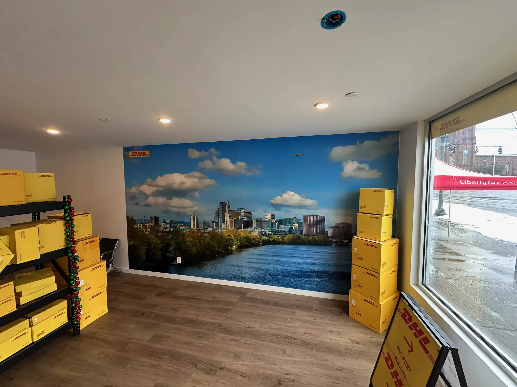 DHL Hartford skyline wall mural flanked by stacked yellow boxes