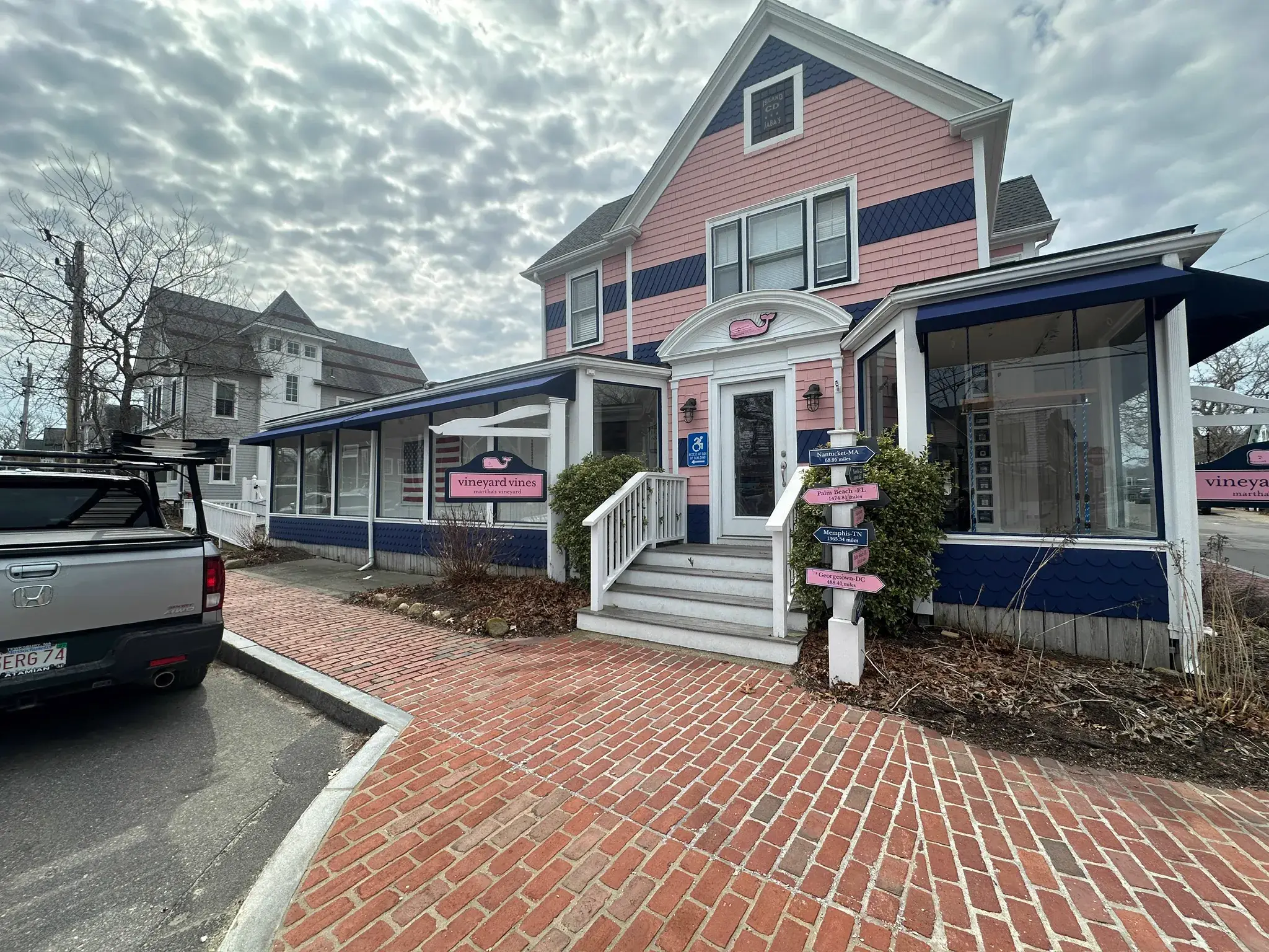 vineyard vines corner store with printed window panels and a loaded pickup outside