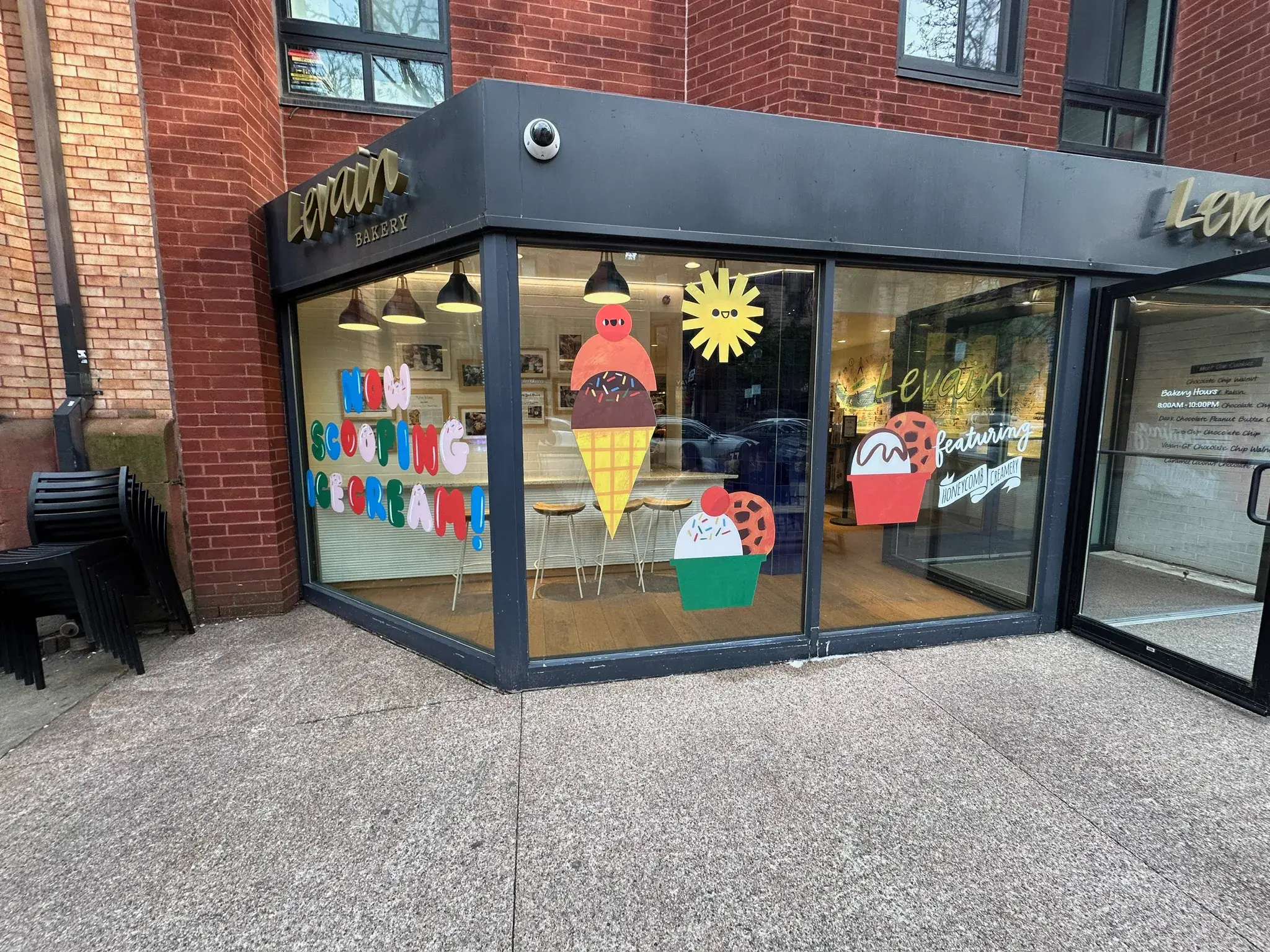 Corner brick storefront with Levain Bakery lettering and ice cream decals