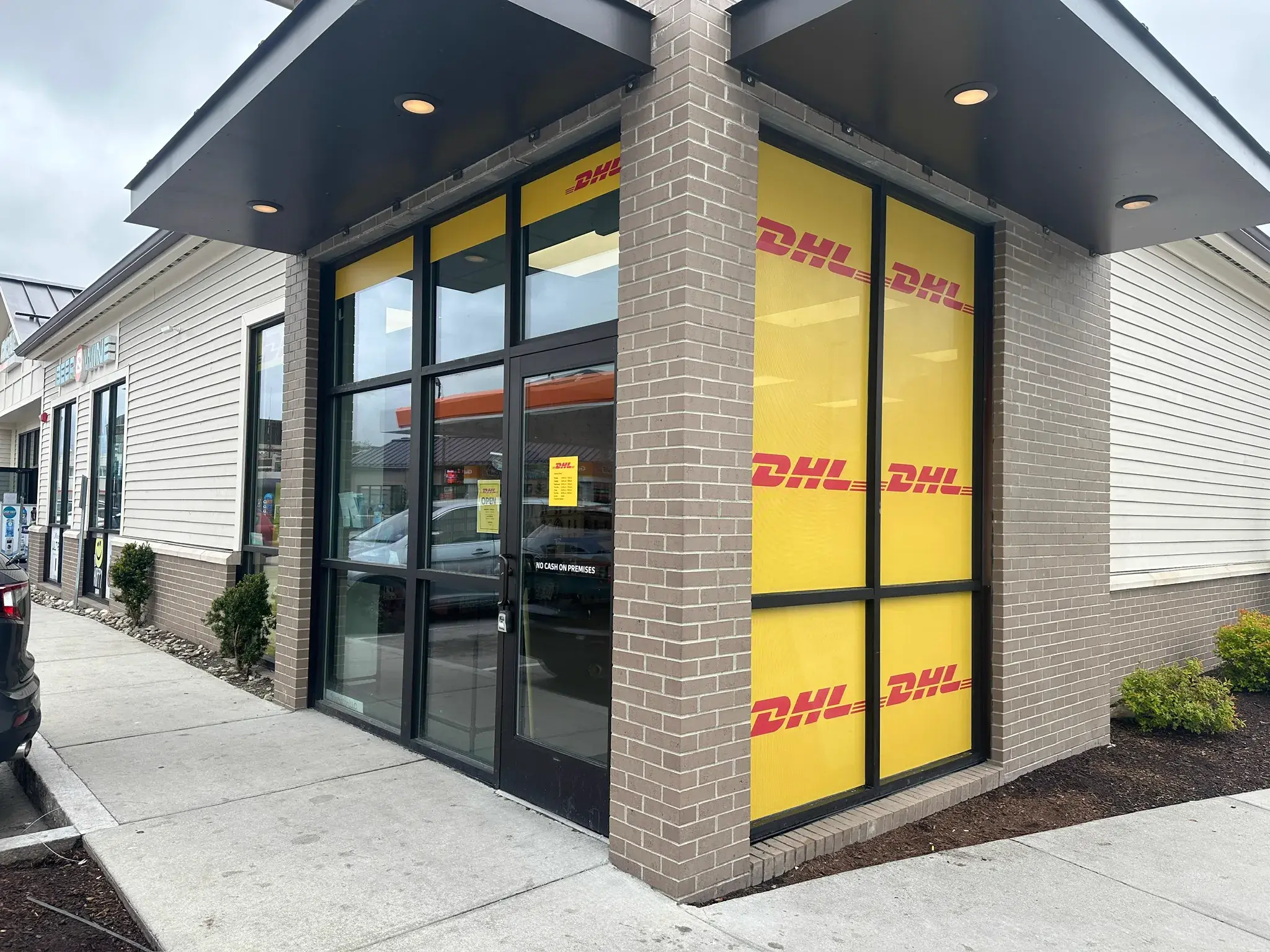 Corner storefront with full yellow DHL logo window film