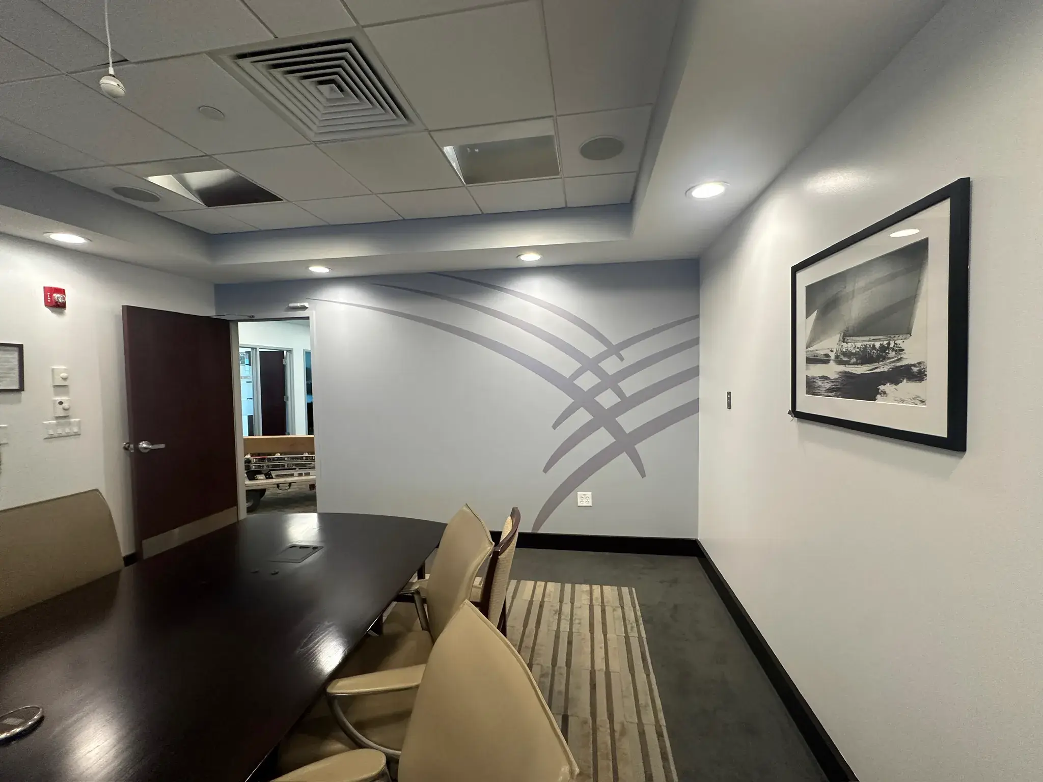 Conference room with a large grey curved line graphic on the end wall
