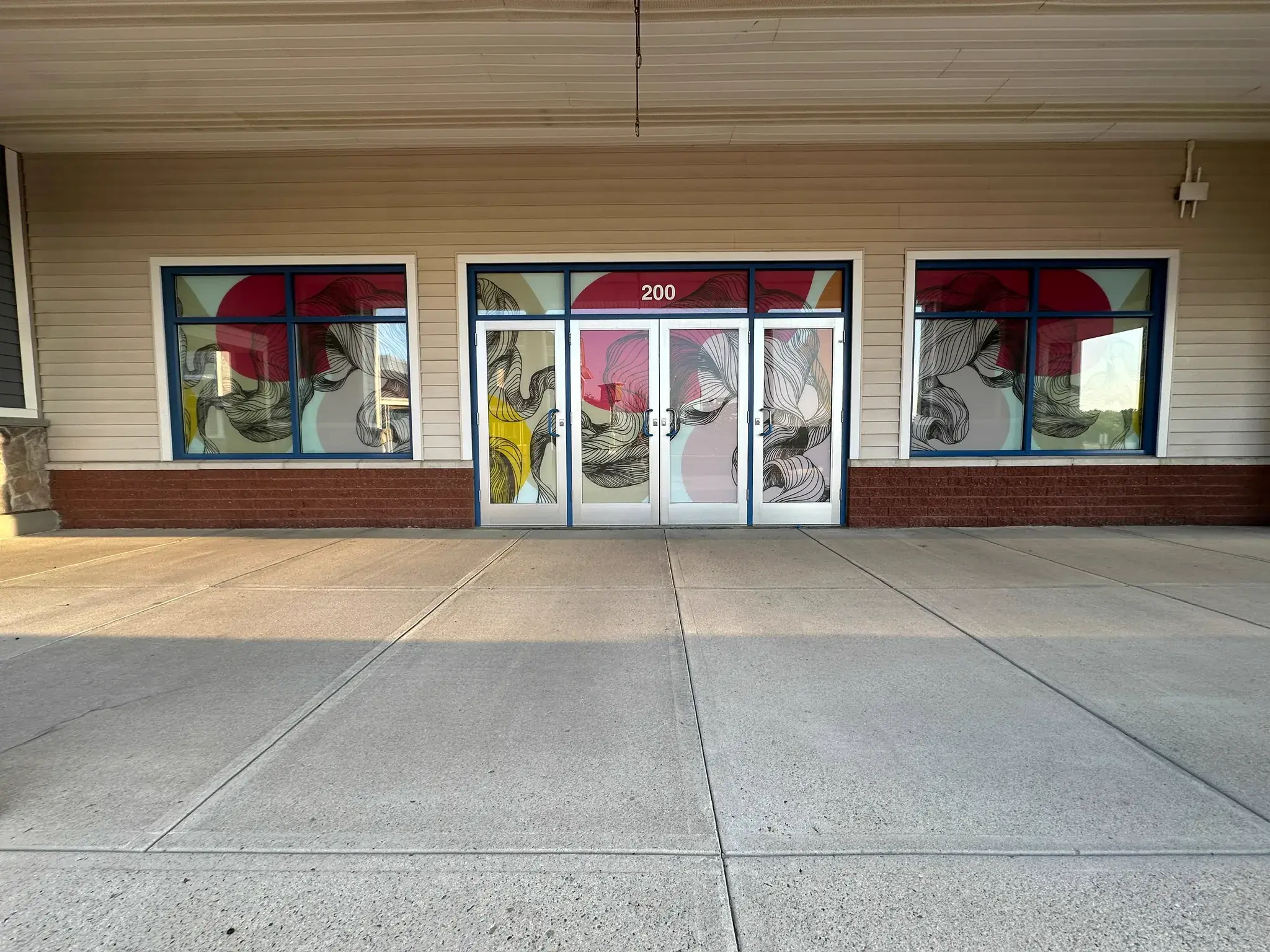 Storefront entrance with abstract flowing line art window film