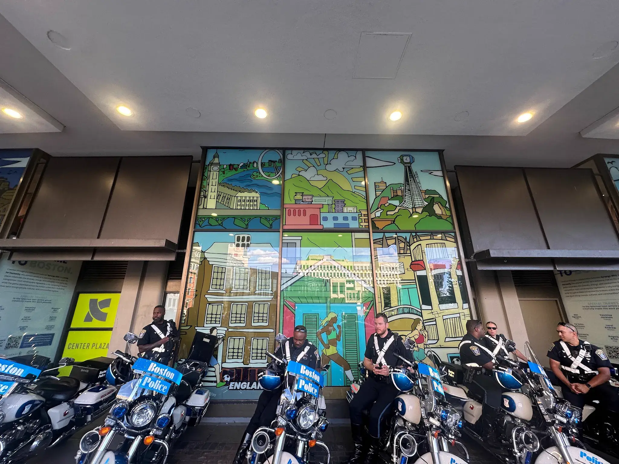 Two storey illustrated window panels at Center Plaza with police motorcycles parked outside