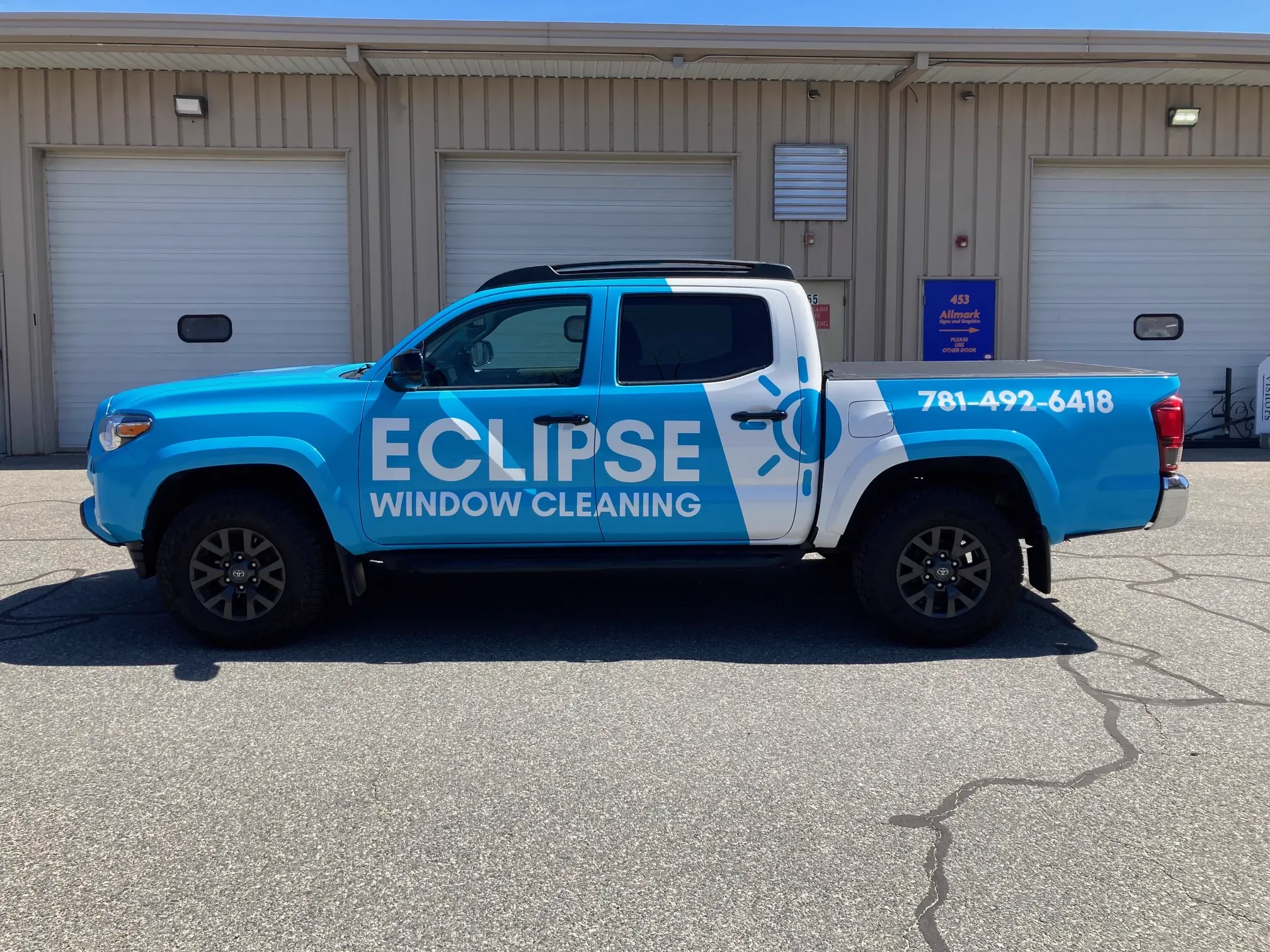 Toyota Tacoma pickup wrapped in a light blue Eclipse Window Cleaning livery