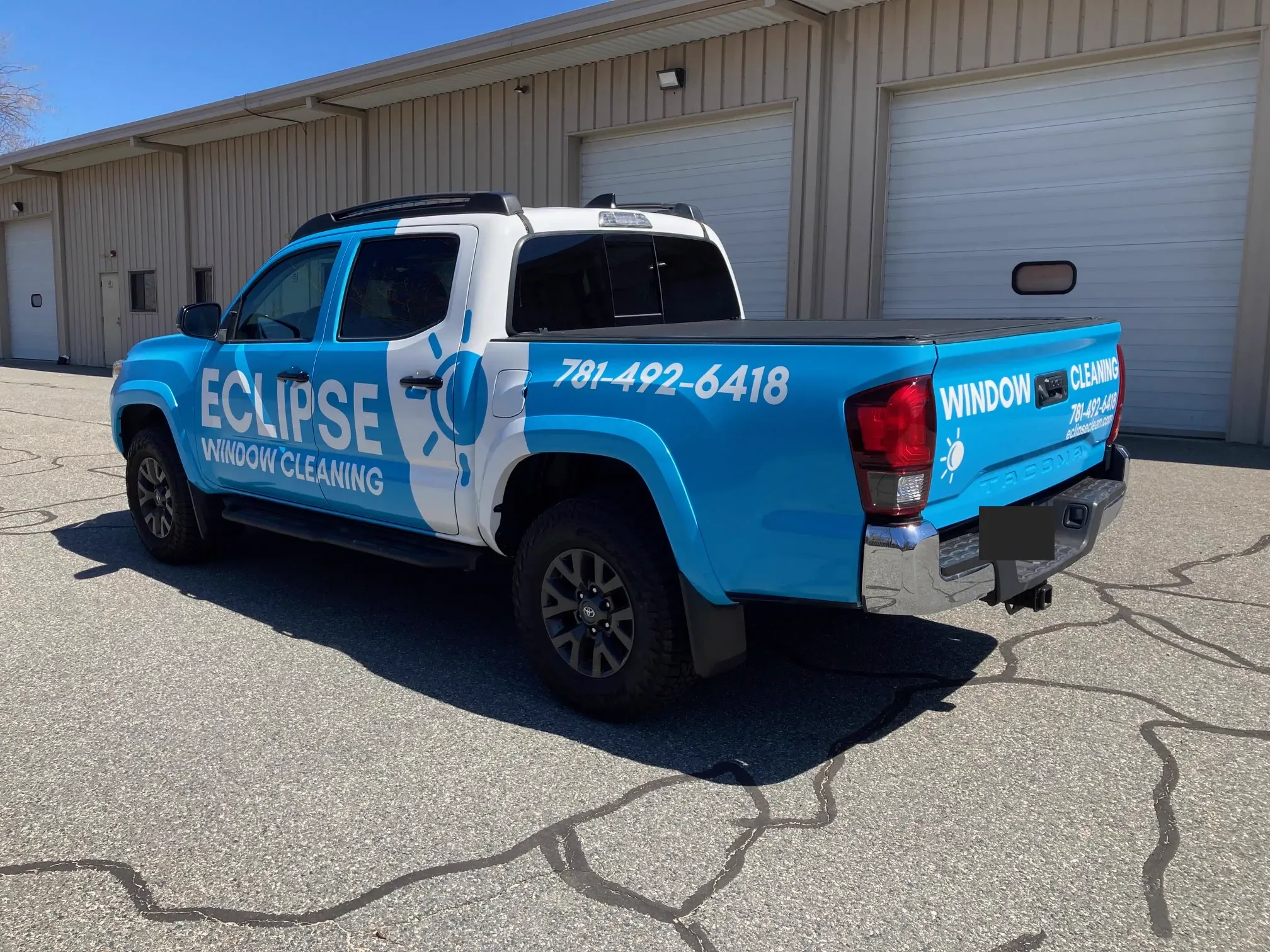 Rear three-quarter view of the wrapped Eclipse Window Cleaning pickup