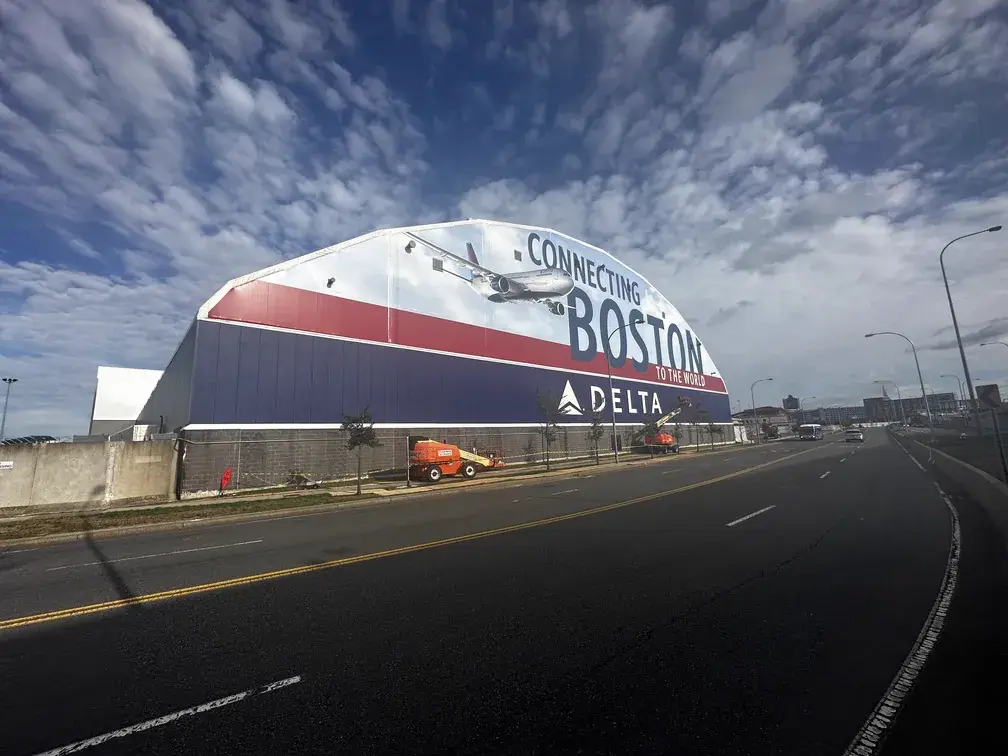 Delta Air Lines hangar at Boston Logan Airport wrapped with a full-height aircraft graphic
