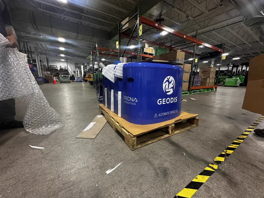 GEODIS branded autonomous warehouse vehicle wrapped in blue vinyl