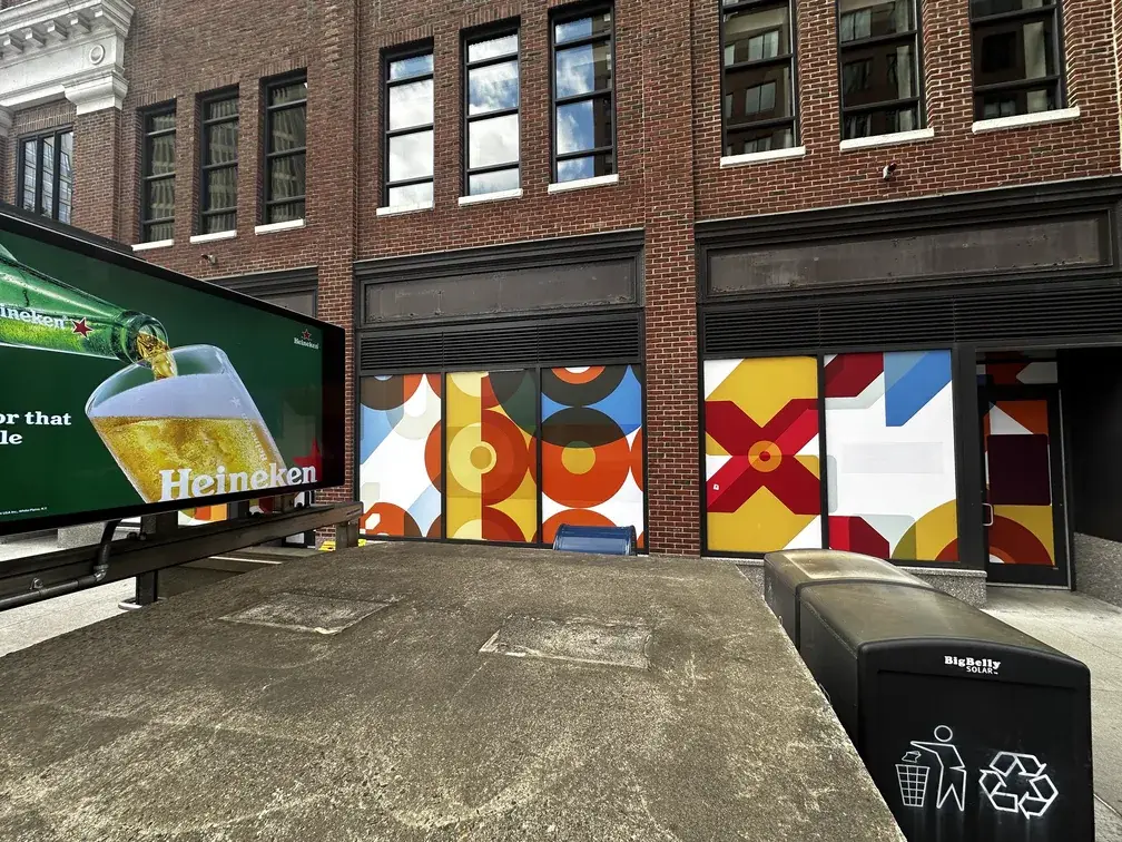 Geometric coloured window graphics on a street level retail unit