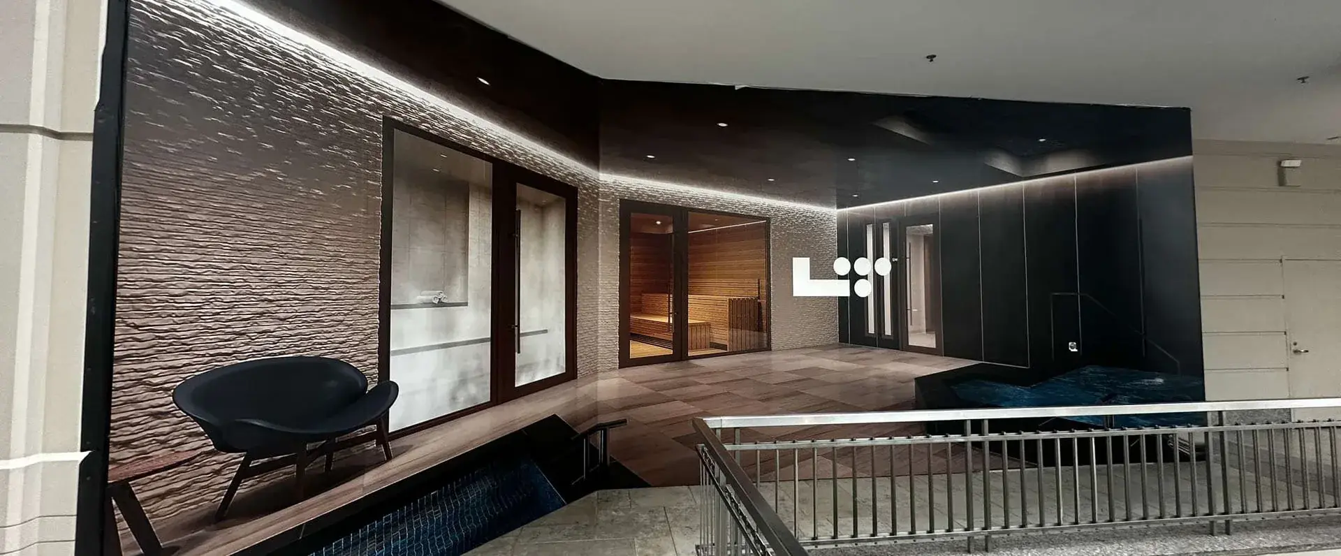 Large-format hoarding showing a spa amenity space rendering